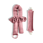 A set of candy pink heatless curlers for side sleepers. and a hair tie, made from Peau De Soie fabric, with gold clasps.