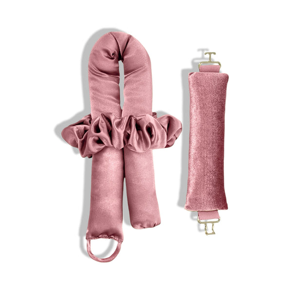 A set of candy pink heatless curlers for side sleepers. and a hair tie, made from Peau De Soie fabric, with gold clasps.